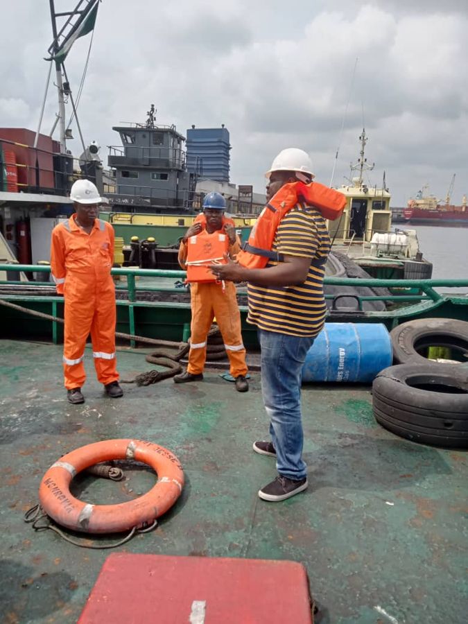 Crew and a safety lifebuoy on deck during a drill